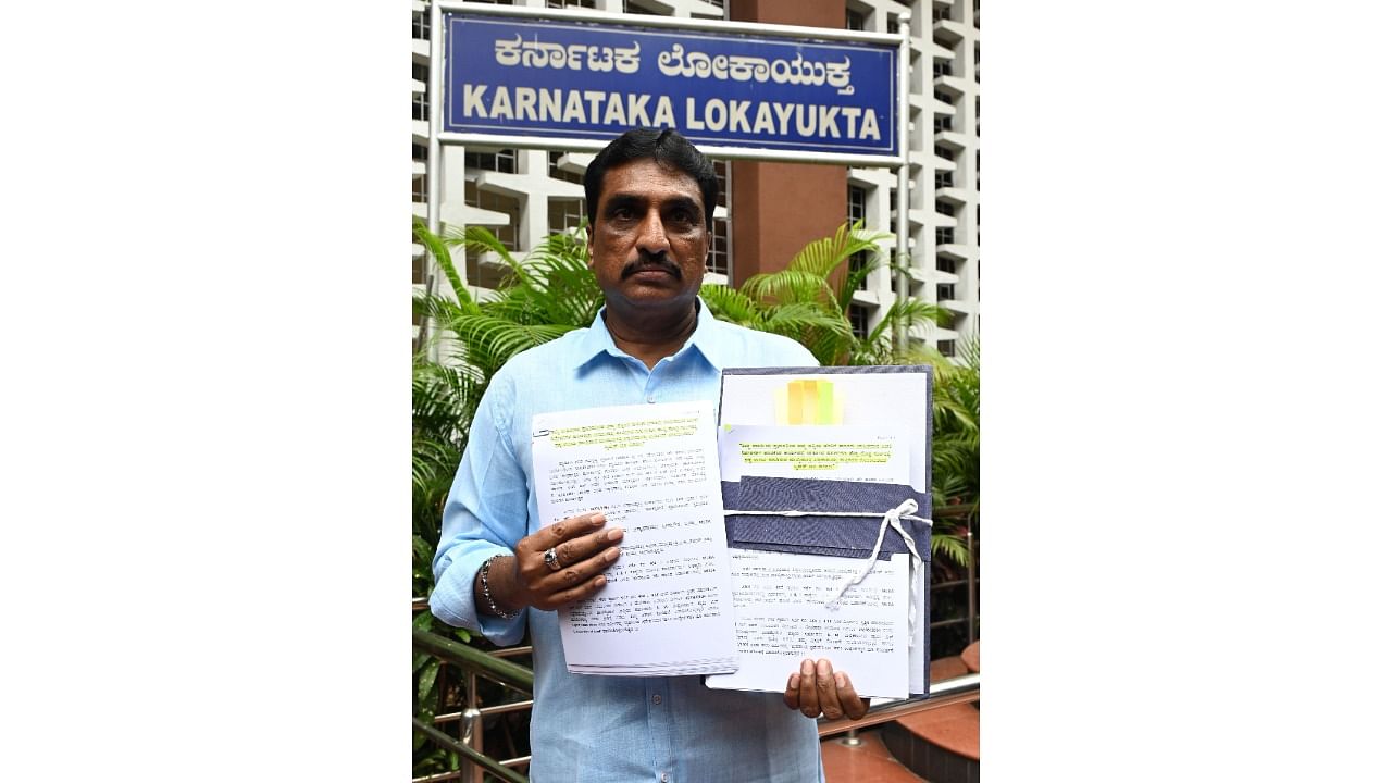 <div class="paragraphs"><p>BJP leader N R Ramesh shows the complaint copy and documents in Bengaluru on Saturday.</p></div>